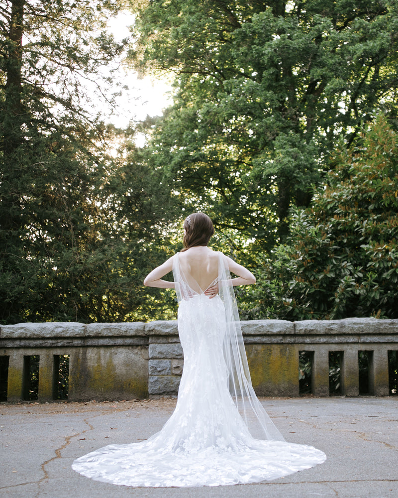 A back view of a model wearing the Aster Cape Veil in chapel length.
