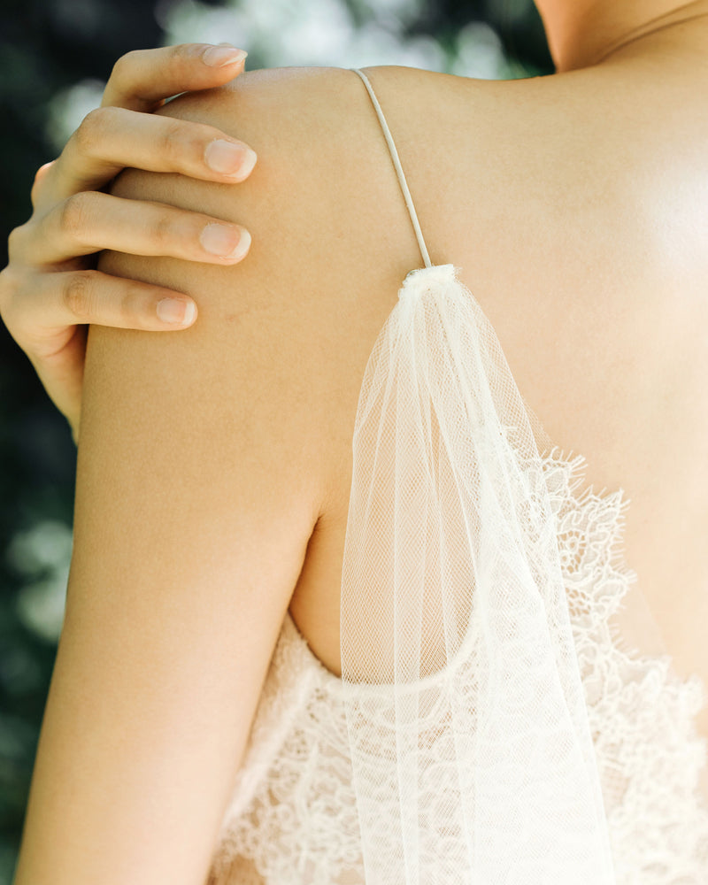 A close view of how the Aster Cape Veil attaches to a bodice with narrow spaghetti straps.