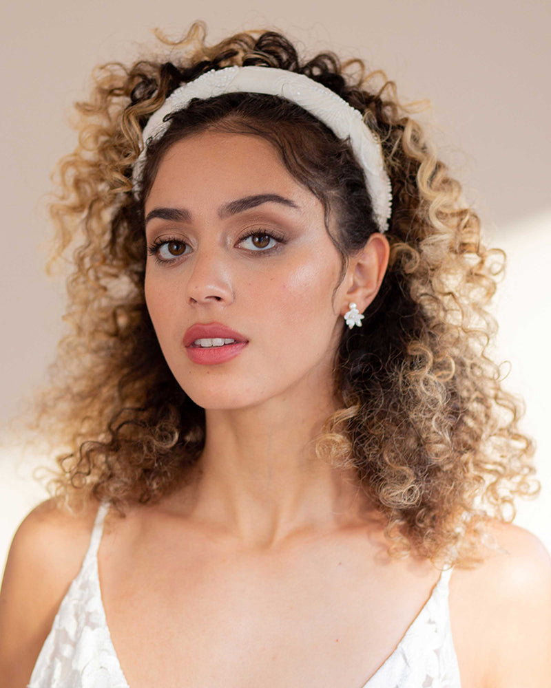 A model wears the Belle Fleur Cluster Earrings with the Camellia Padded Headband.