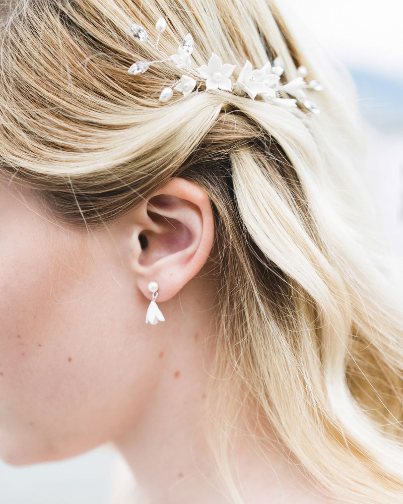 Close up of a blonde model wearing the Belle Fleur Petite Bridal Earrings shown with the Belle Fleur Comb; clay flowers and freshwater pearls.