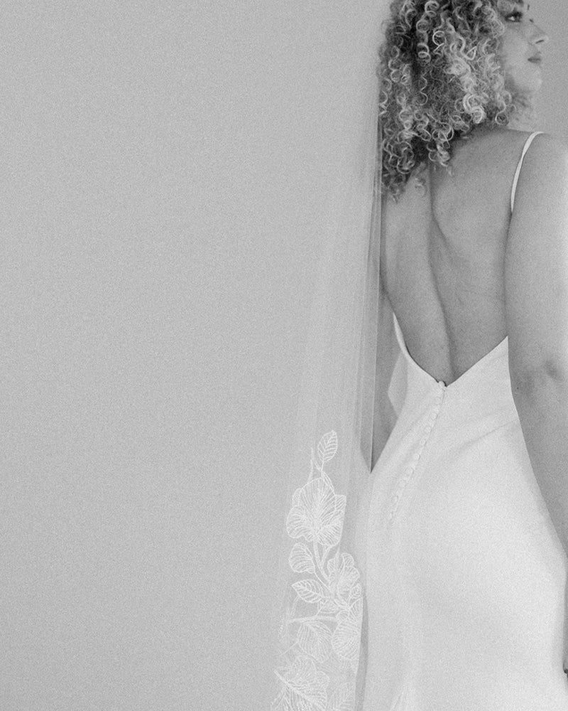 A black and white view of the Camellia Beaded Lace Veil in fingertip length.