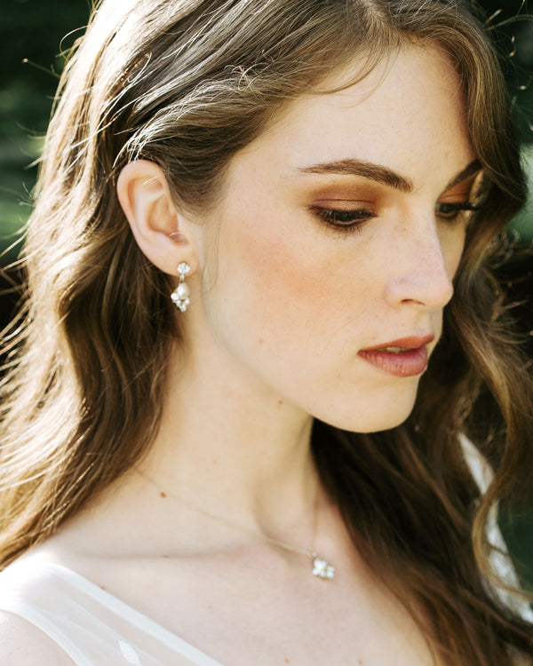 A model with auburn hair wears the Celestial Pearl Drop Jewelry Set. The delicate pearl drop necklace matches her pearl drop earrings.