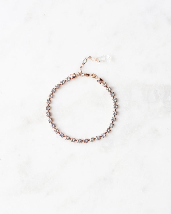 Flatlay of the Delicate Tennis Bracelet in rose gold.