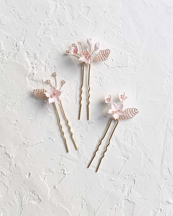 Flatlay view of the Lily Floral Hair Pins in gold with blush flowers and blush beads.