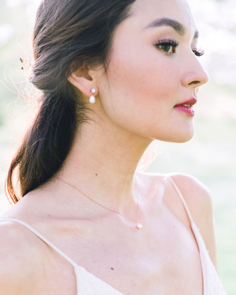 A bride wears a classic Teardrop Pearl Jewelry Set in rose gold.
