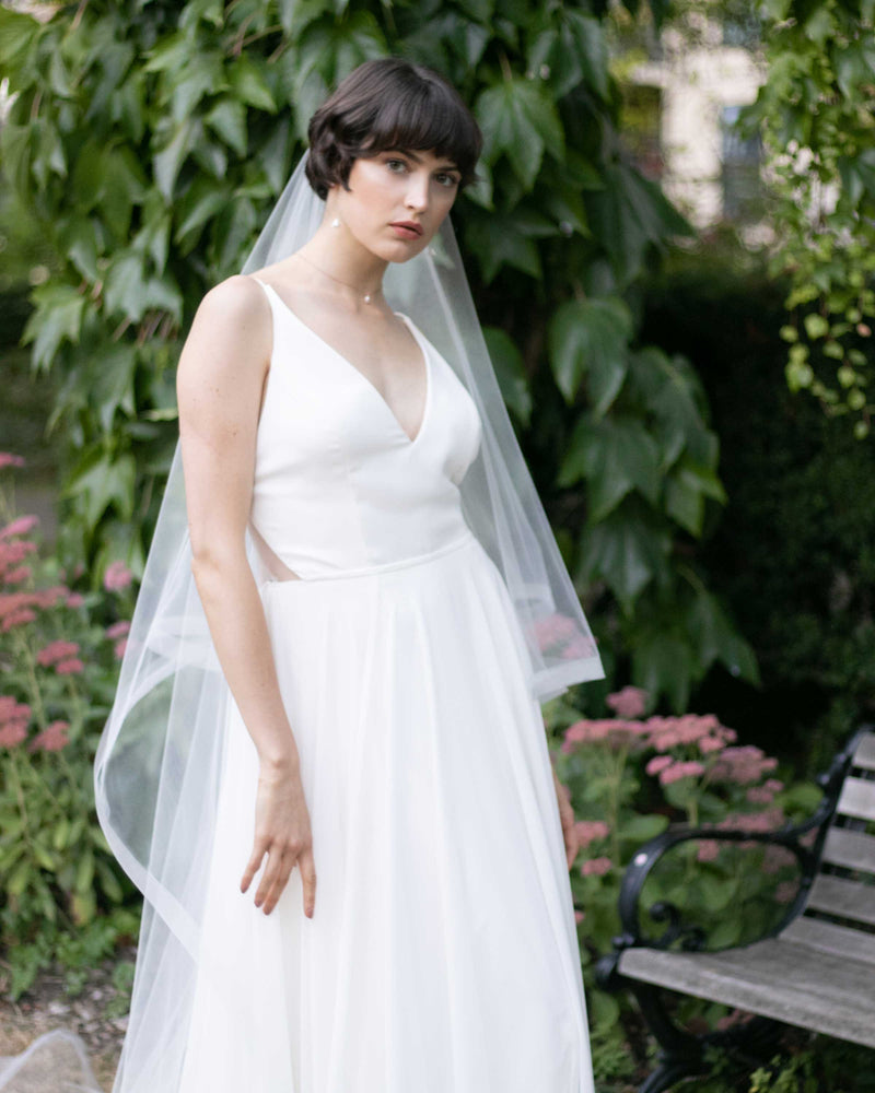A bride models the Zahra Veil; a long two layer veil with 1" nylon horsehair braided trim.