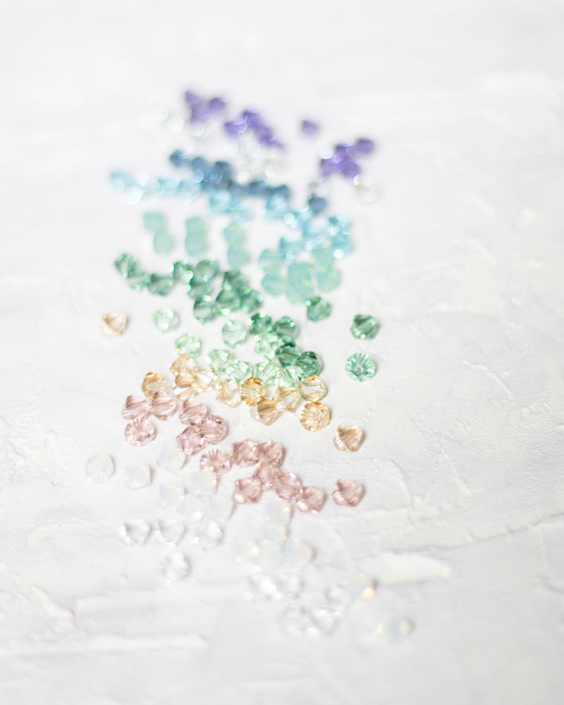Scattered crystals displayed in the 12 colors available in the bridesmaid jewelry collection.