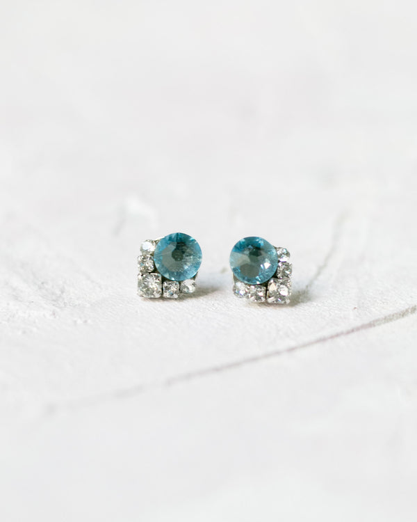 Closeup view of the Celestial Crystal Cluster Earrings in silver with an aquamarine center crystal.