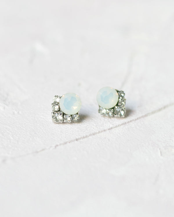A close up product only photo of the Celestial Crystal Cluster Earrings in silver with white opal crystals.