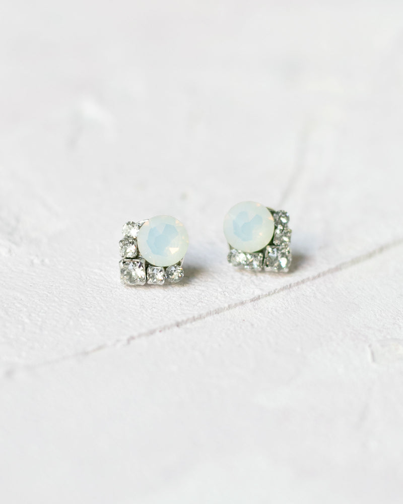 A close up product only photo of the Celestial Crystal Cluster Earrings in silver with white opal crystals.