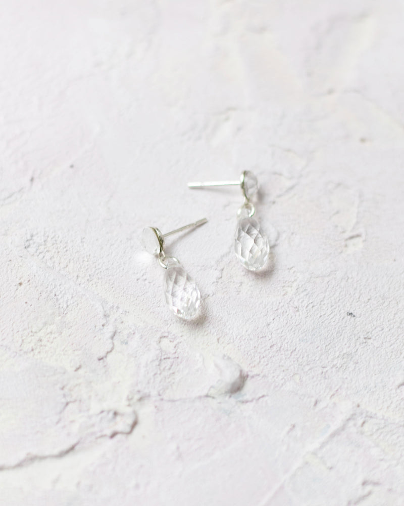 Flatlay of the Dewdrop Earrings in silver with crystal.