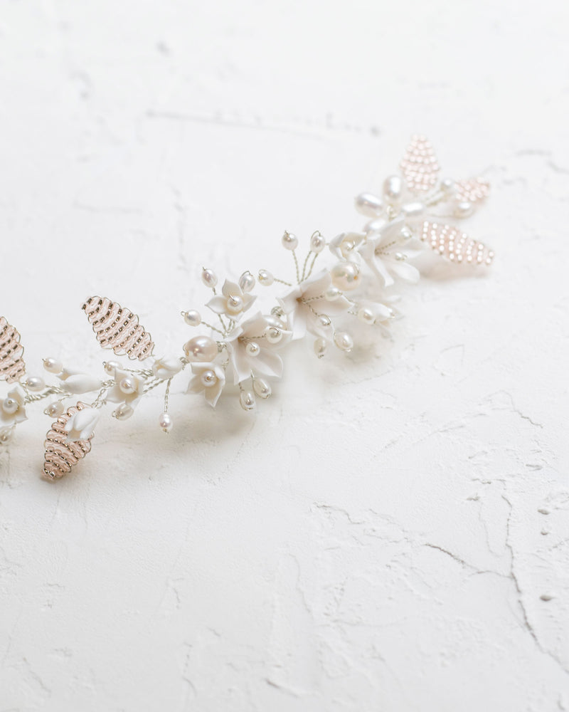 Close flatlay view of the Lily Floral Comb in silver with blush beading and ivory flowers.