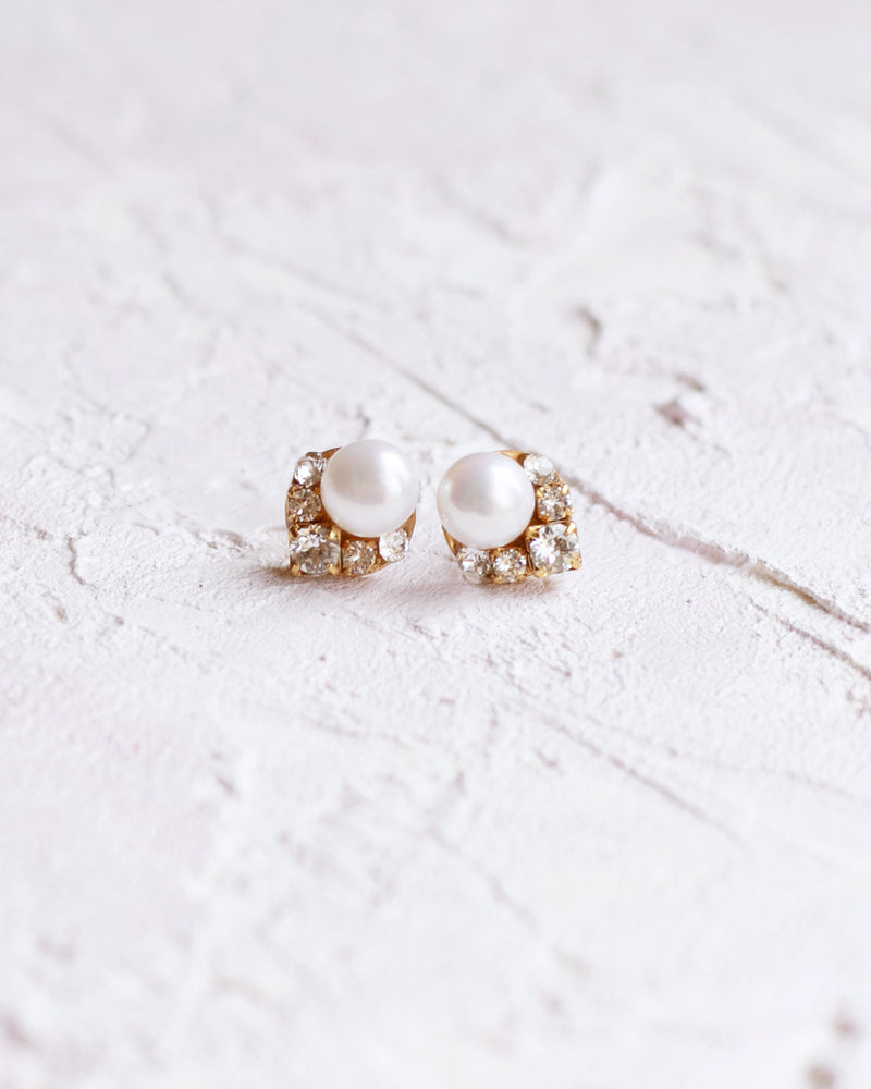 Flatlay view of the Petite Celestial Cluster Pearl Earrings in gold with freshwater pearls.