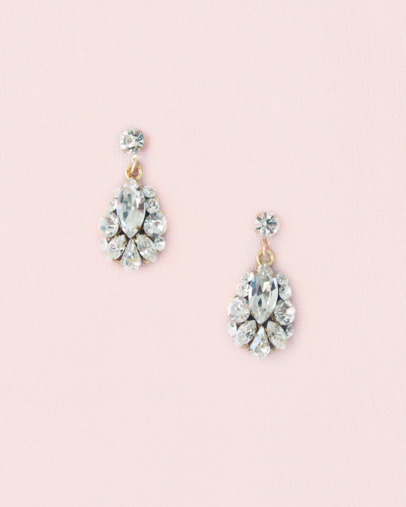 Flatlay view of the Petite Crystal Drop Earrings in gold with crystals.