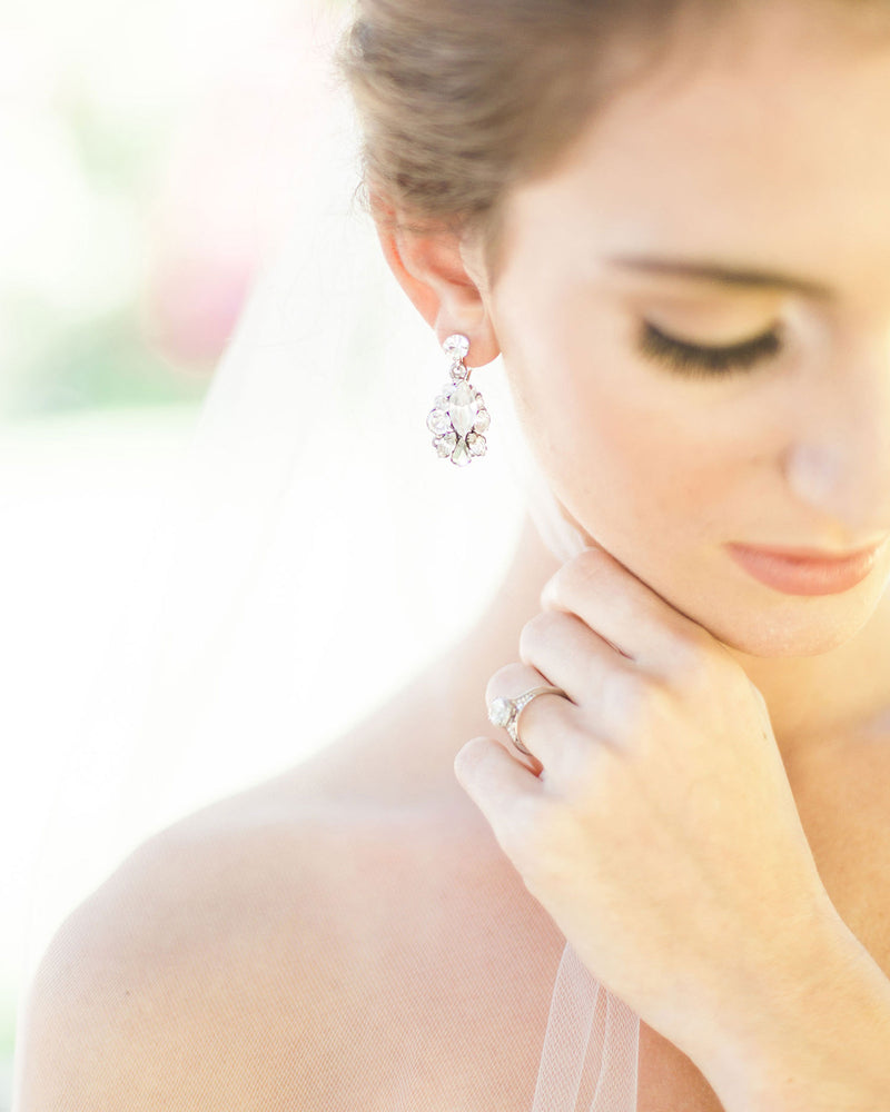 Bride wearing crystal drop earrings in silver