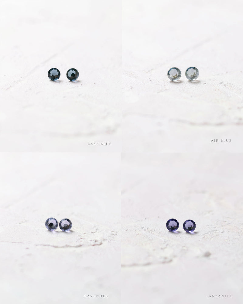 Close product view of the Starry Eyed Stud Bridesmaid earrings in lake blue, air blue, lavender, and tanzanite.