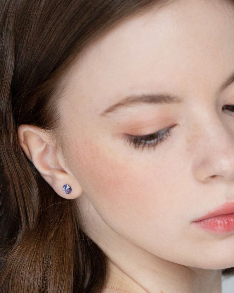 A bridesmaid wears the Starry Eyed Bridesmaid Earrings with tanzanite crystal.