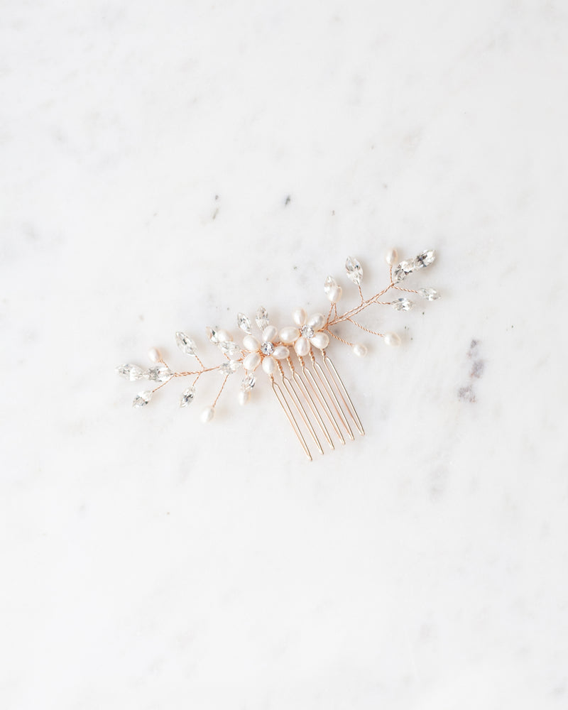 Flatlay view of the Aster bridal hair Comb in rose gold with pearls and crystals.
