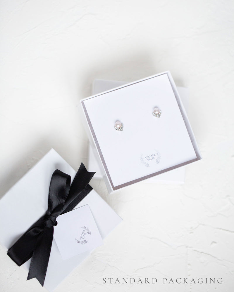 An example of our standard jewelry box packaging, complete with black satin bow.
