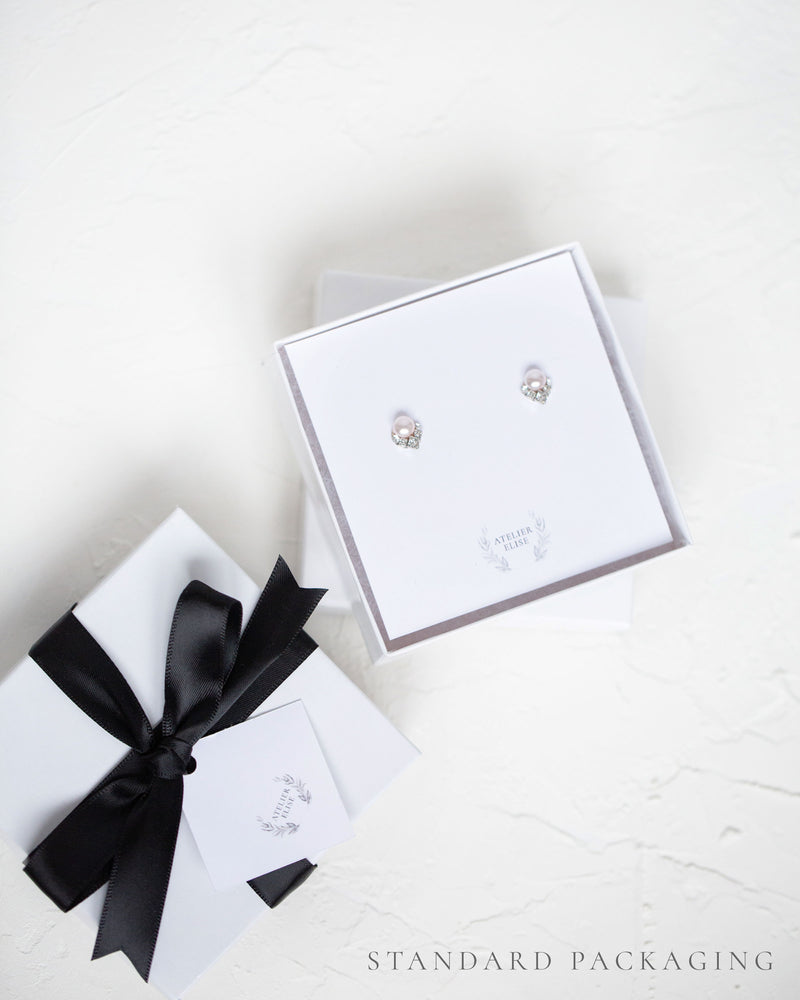 An example of our standard jewelry box packaging, complete with black satin bow.