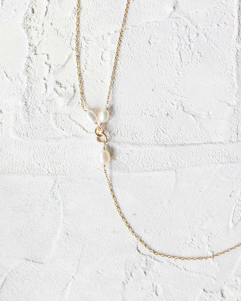 Flatlay view of how the Pearl Back Drape attaches to any necklace.