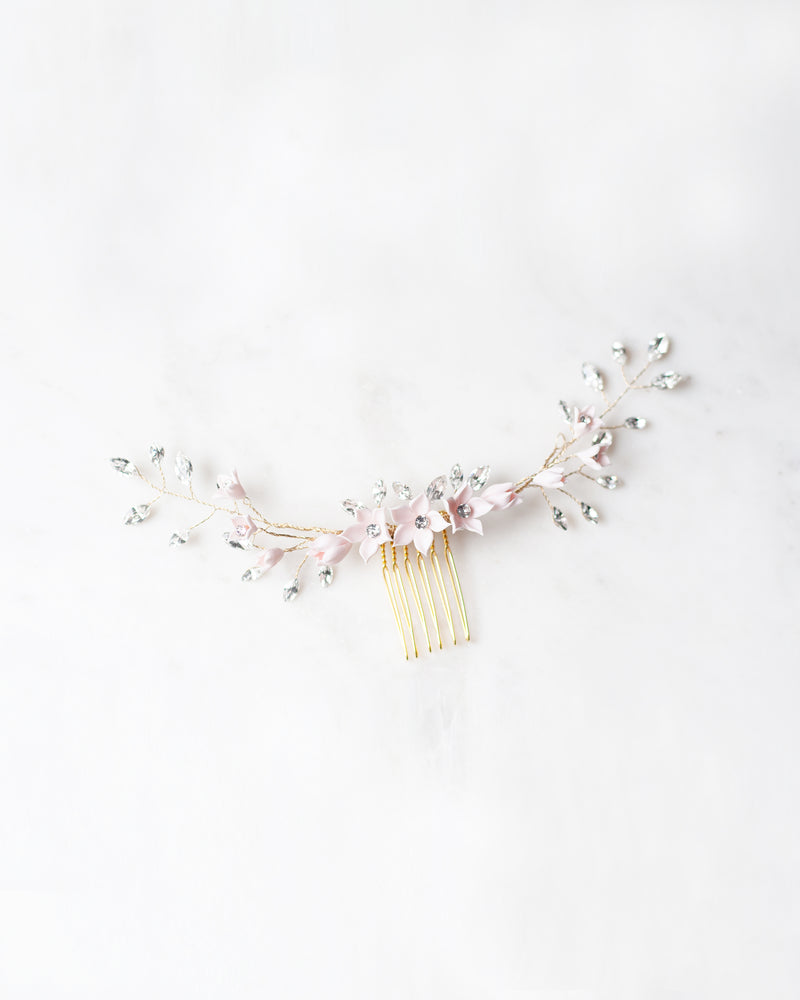 Flatlay photo of the Belle Fleur Grand Comb in gold with blush flowers and crystals.