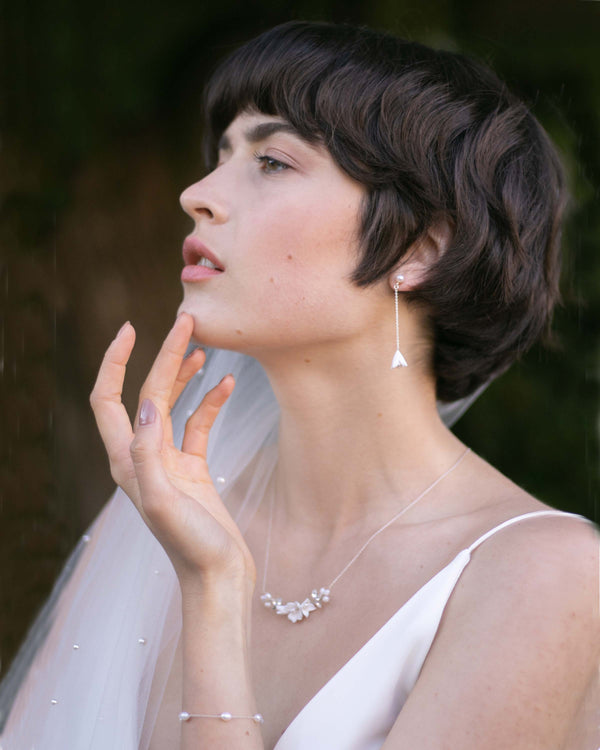 A bride models the Belle Fleur Drop Jewelry Set in silver.