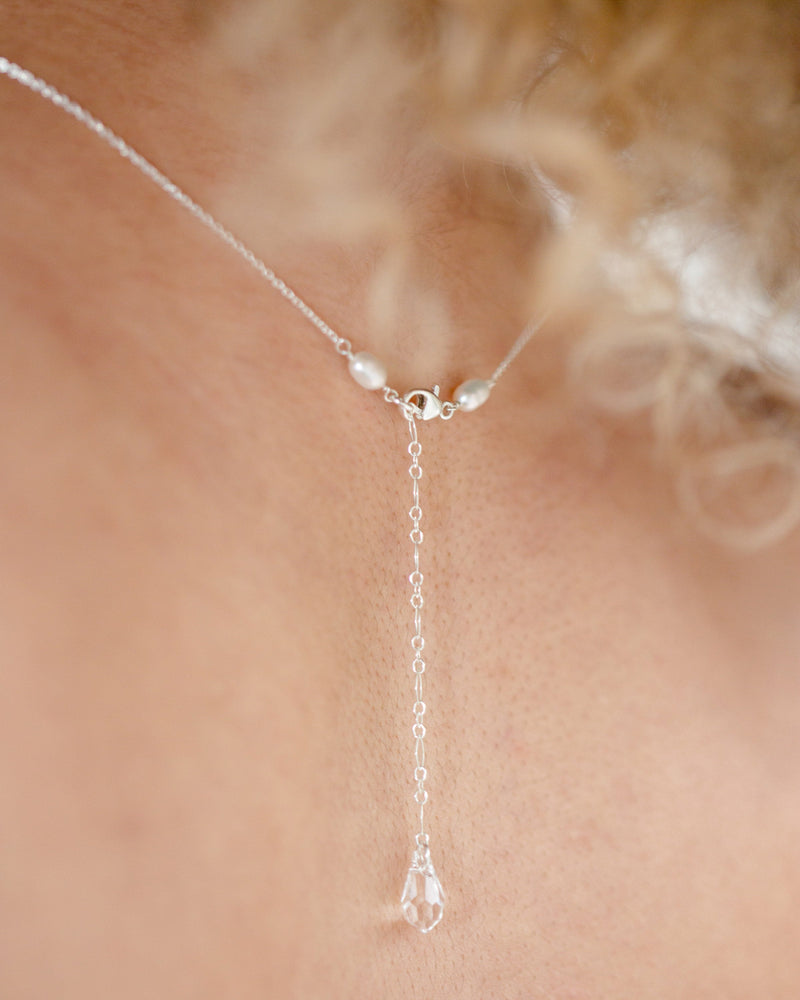 Close view of the back of the Belle Fleur Necklace, featuring a toggle clasp and dainty crystal on an extender.