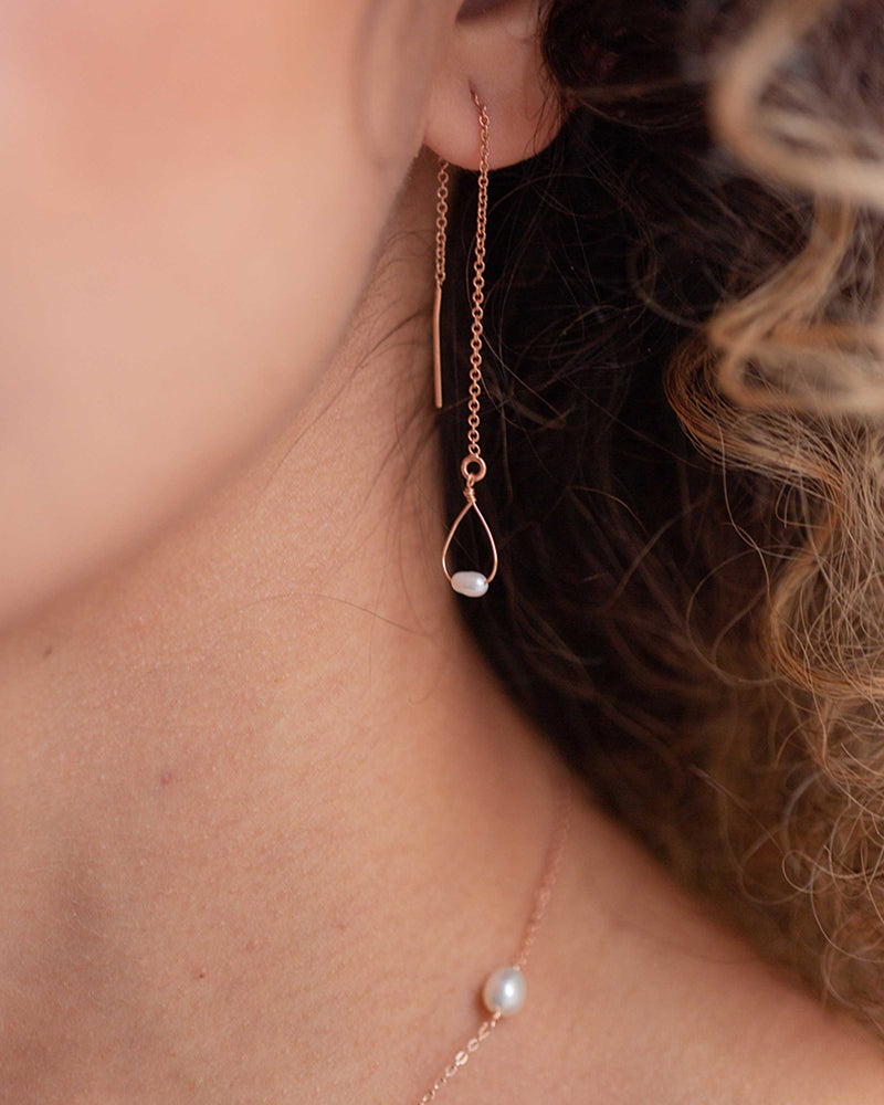 Close model view of the Bria Threader Earrings in rose gold.
