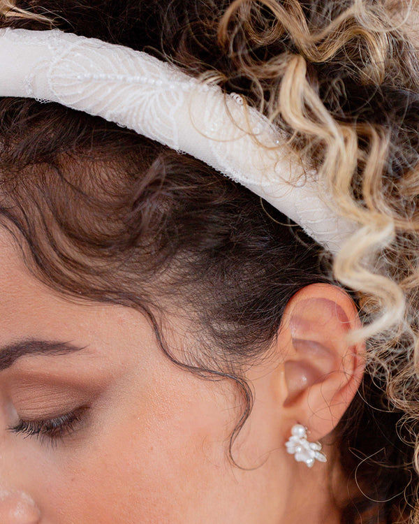 A close model view of the beaded lace on the Camellia Padded Headband.