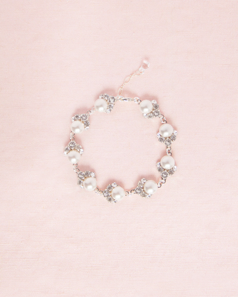 Flatlay view of the Celestial Pearl Cluster Bridal Bracelet in silver with white pearls.