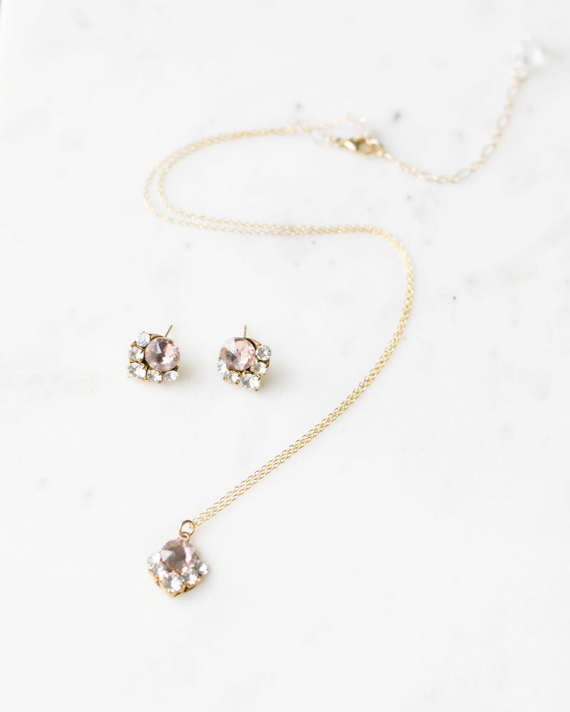 A flatlay view of the Celestial Crystal Jewelry Set in gold with blush crystals.