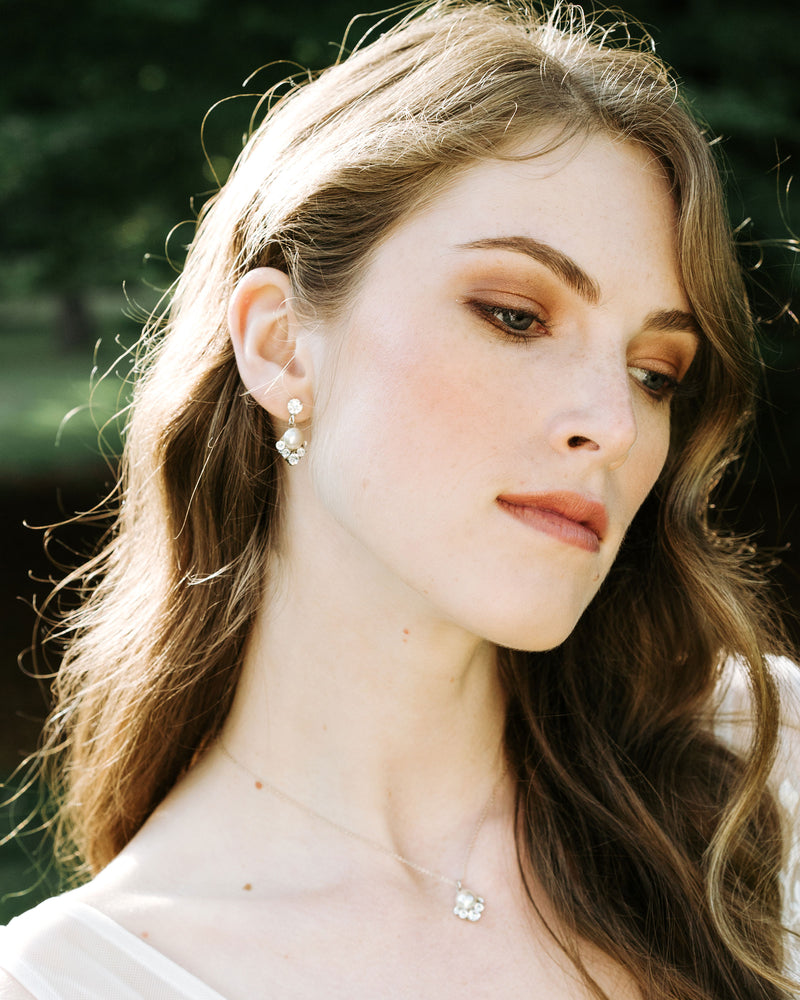A model with auburn hair wears the Celestial Pearl Drop Jewelry Set. The delicate pearl drop necklace matches her pearl drop earrings.