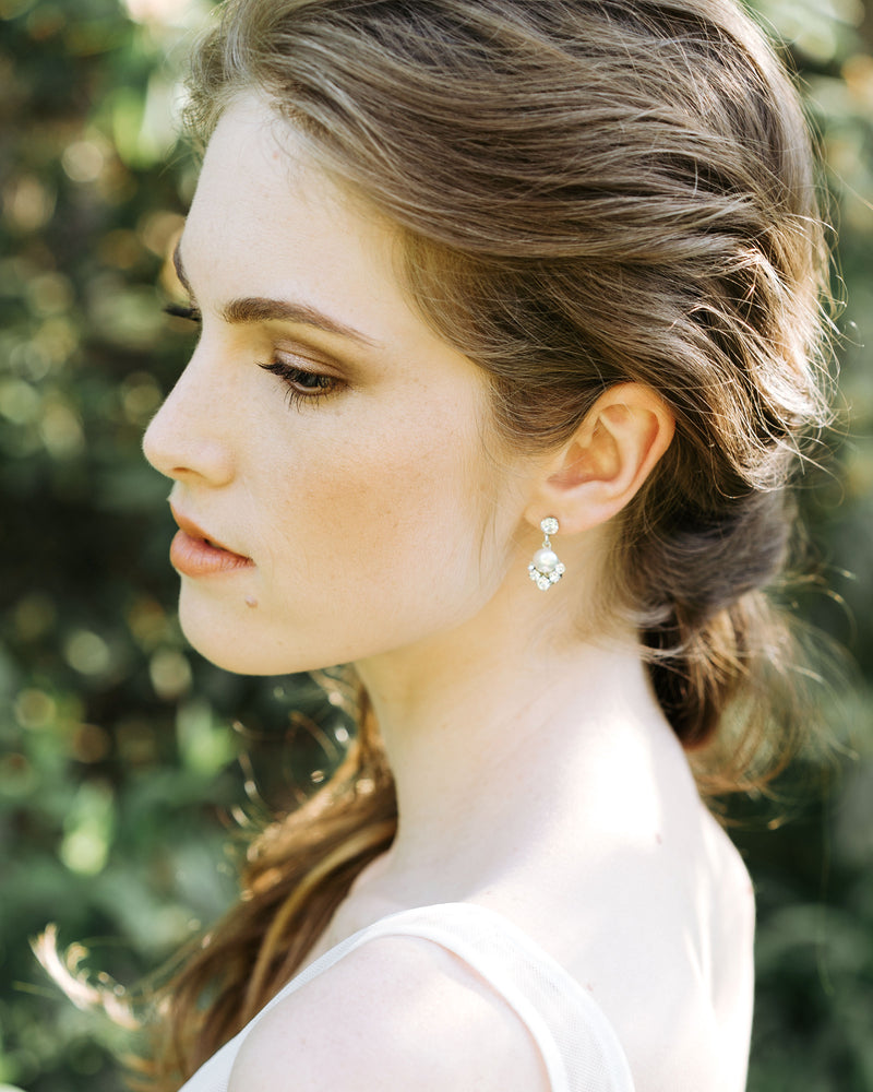 An auburn haired model wears the Celestial Pearl Drop Earrings in silver with white pearls.