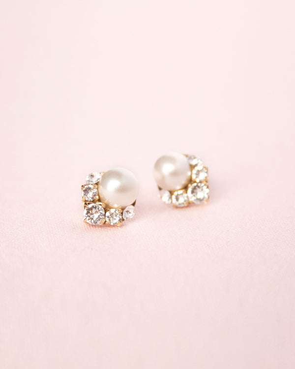 A close up product view of the Celestial Pearl Cluster Earrings with cream faux pearls in gold.