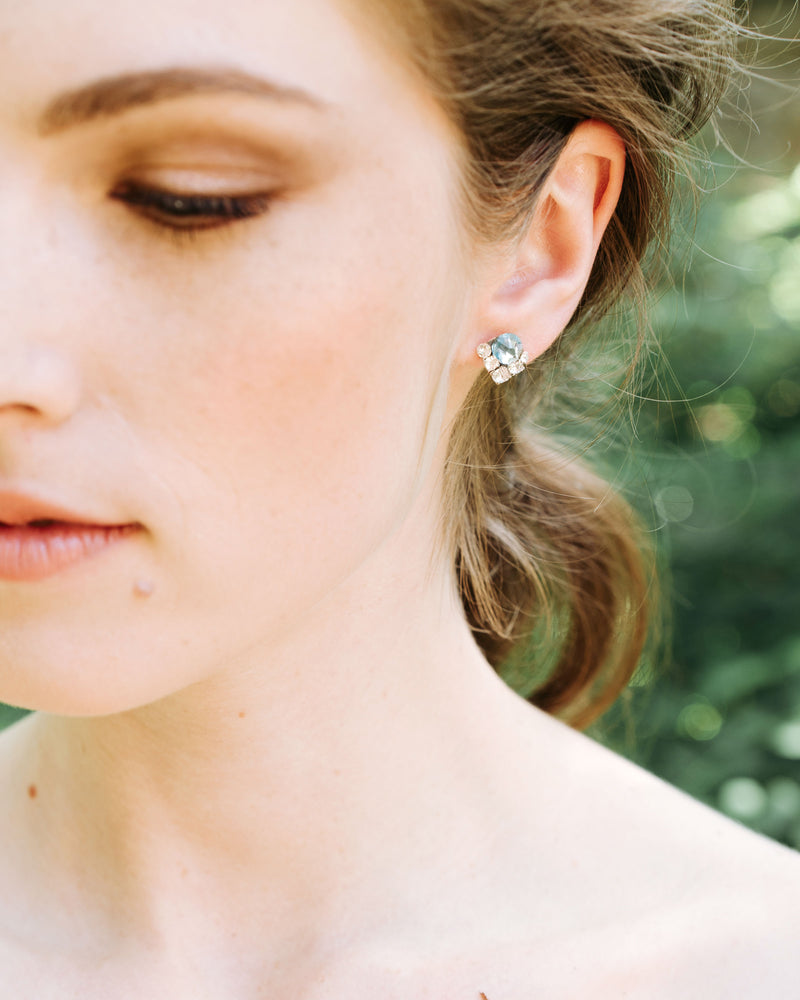 A close model view of the Celestial Crystal Cluster Earrings in silver with aquamarine crystals.