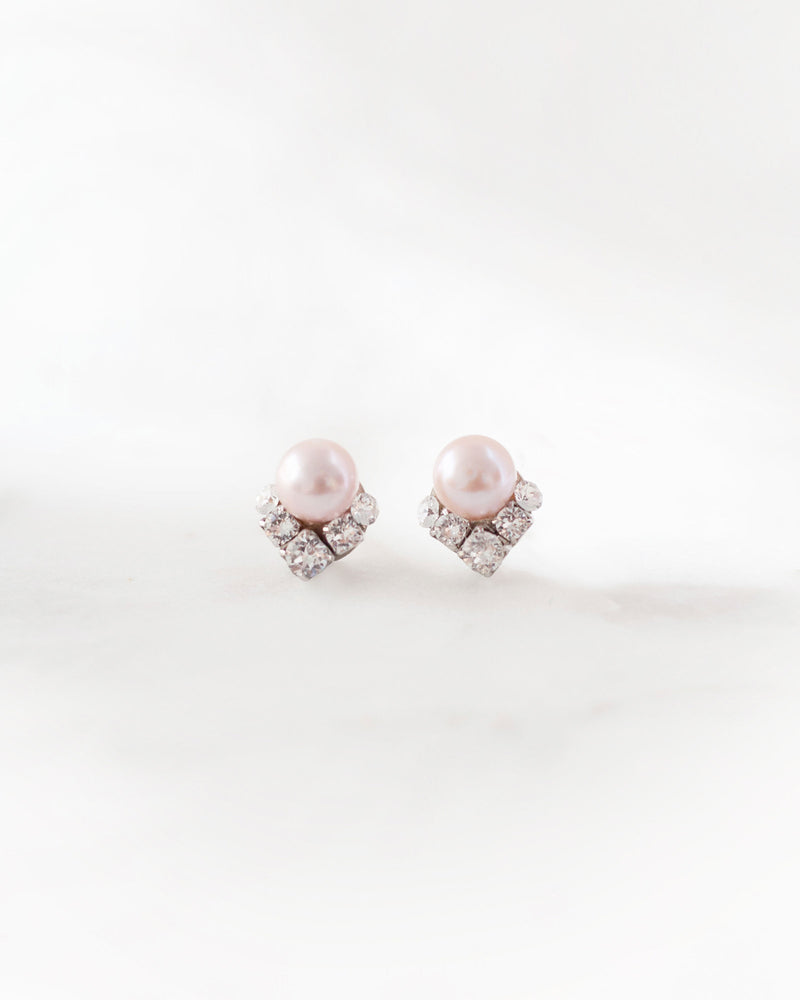 A closeup product view of the Celestial Pearl Cluster Earrings in silver with blush freshwater pearls.