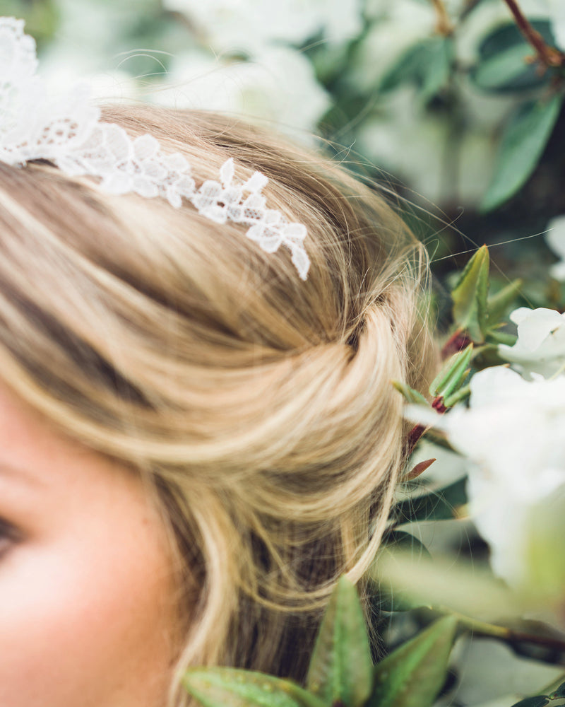 Close details of a bride wearing a chantilly lace wedding tiara