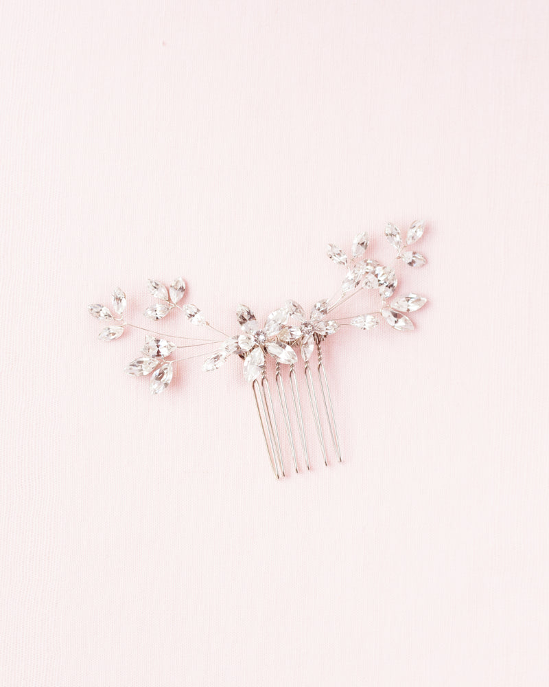 A flatlay of the crystal blossoms petite bridal comb in silver.