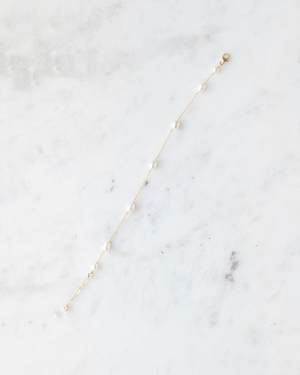 A flatlay of the dainty freshwater pearl bracelet in gold