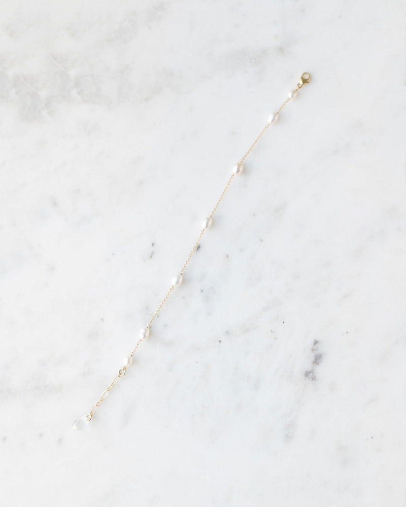 A flatlay of the dainty freshwater pearl bracelet in gold