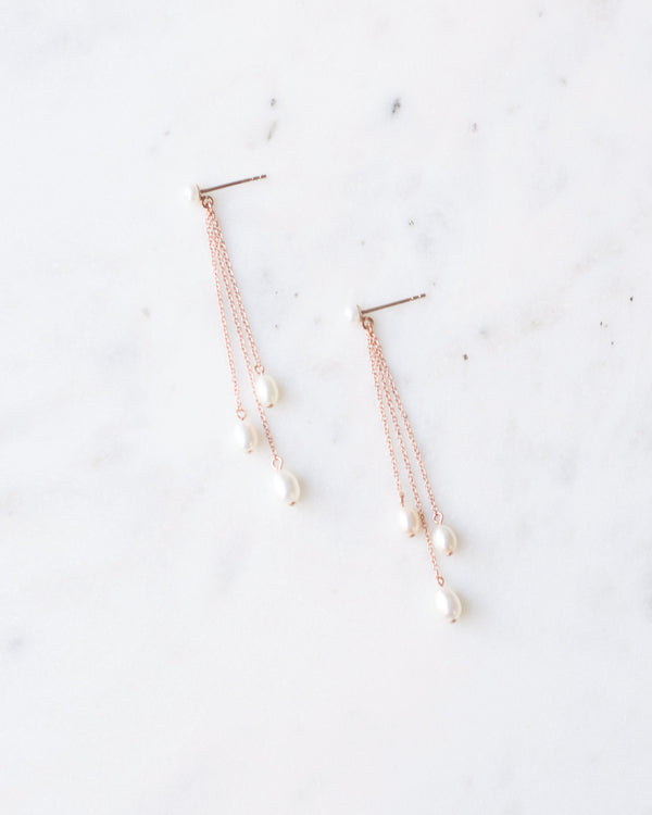 Flatlay of the Dainty Pearl Trio Earrings in rose gold
