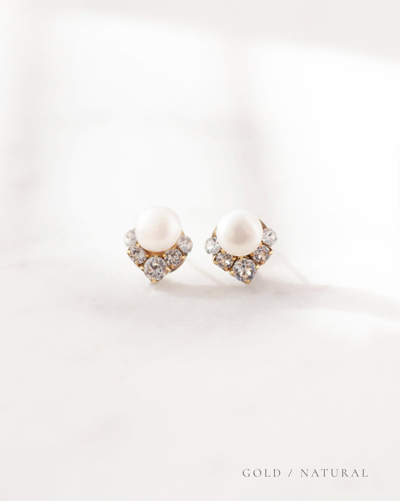 A closeup product view of the Celestial Pearl Cluster Earrings in gold with natural freshwater pearls.