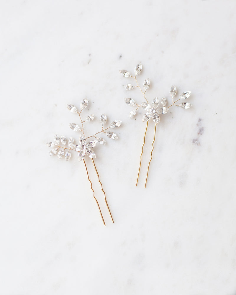 Flatlay view of the Everthine Hair Pins in gold with all crystal.
