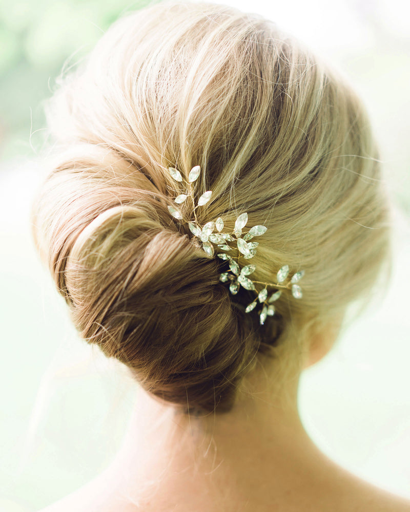 Close model view of the Everthine Crystal Hair Pins styled into a modern bridal French twist. The pins are gold with crystals.