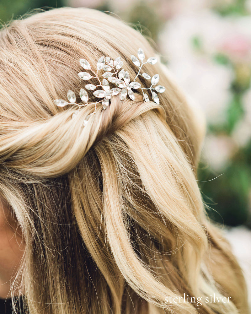 A close model view of the Everthine Crystal Hair Pins in silver. The model's hair is styled into a bridal updo of soft waves, with the sides pinned back.