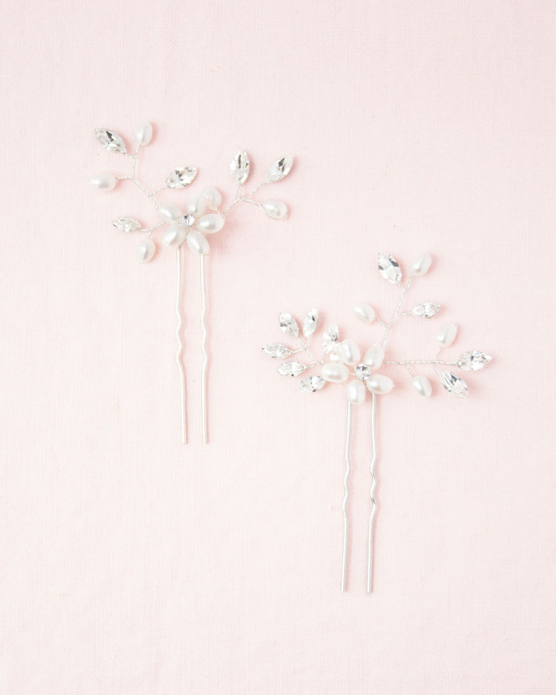 Flatlay view of the Everthine Hair Pins in silver with pearl and crystal.