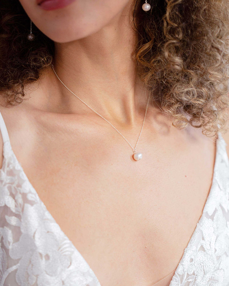 A model wears the Moondrop Pearl Necklace in silver.