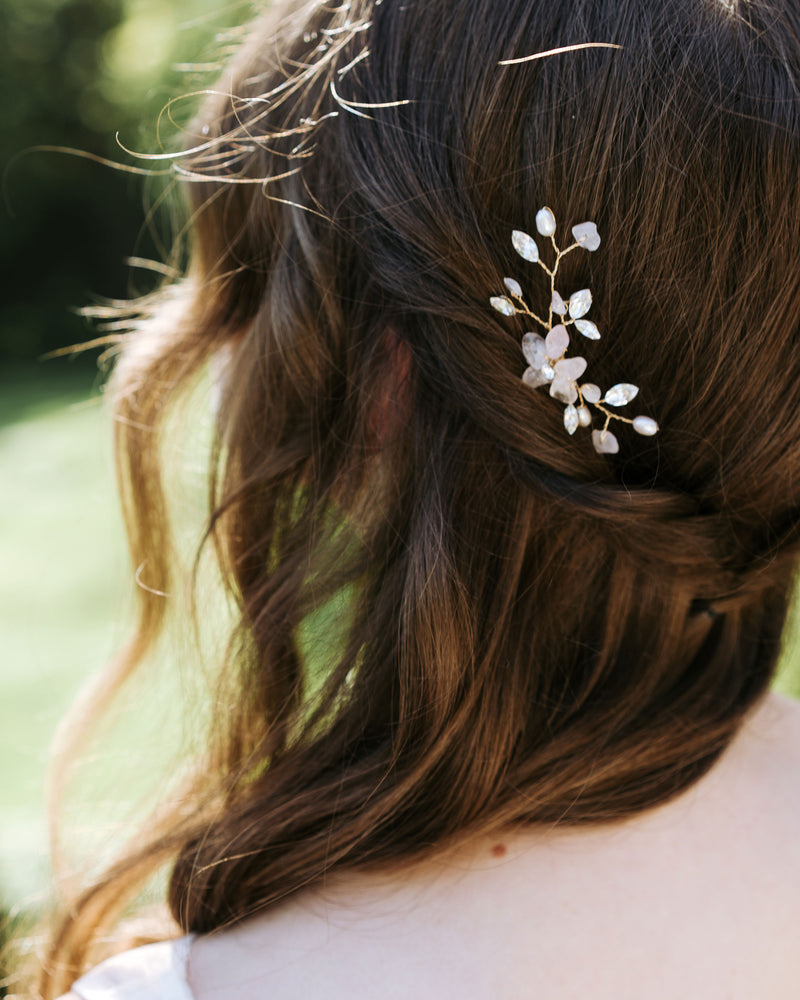 A close view on model of a bride wearing the Moonflower Gemstone Bridal Hair Pin.
