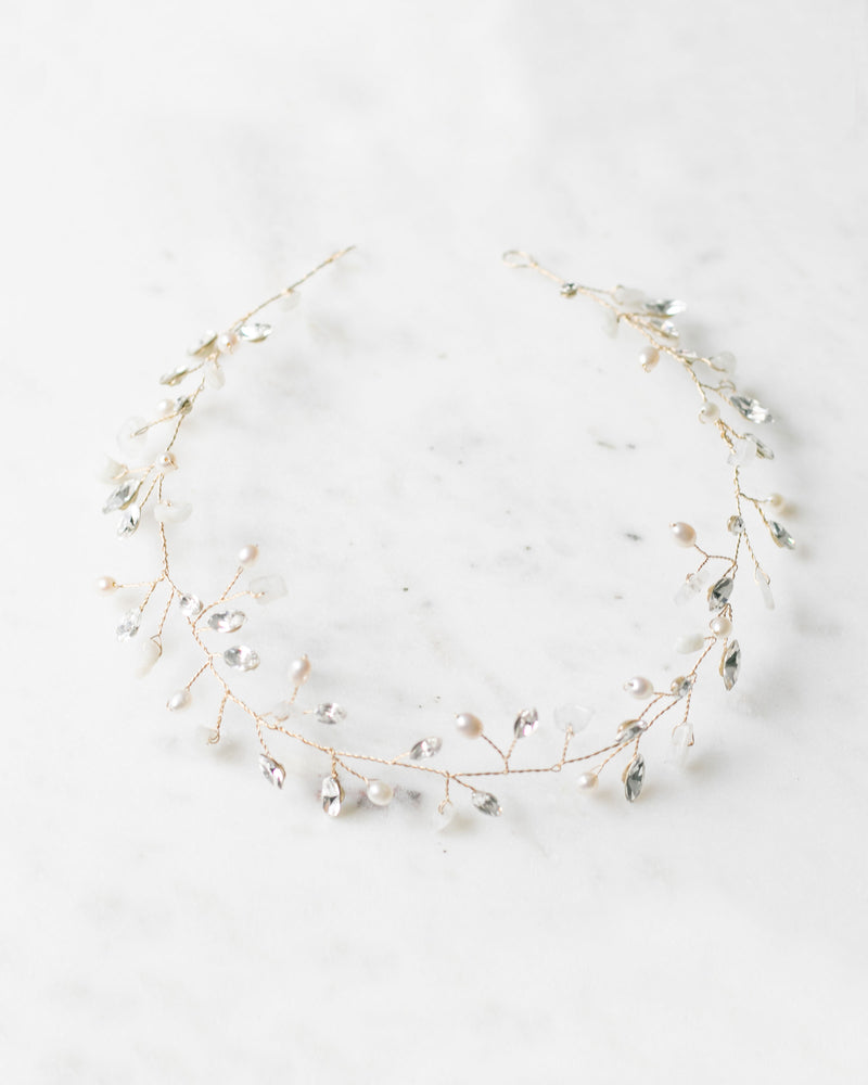 Flatlay of the Moonflower Bridal Hair Vine in gold, with moonstone, pearls, and crystals.